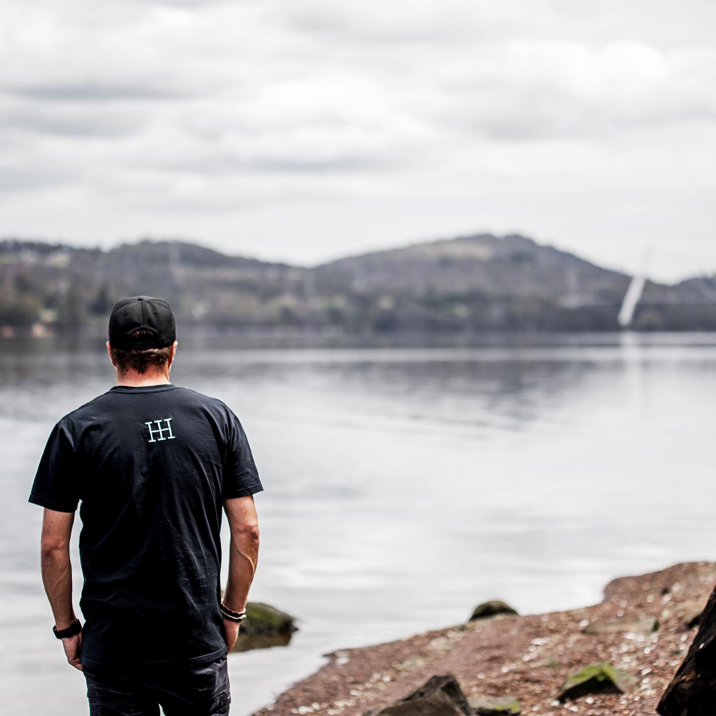Ollie looking out over the Tamar River from the edge of the Tamar Valley next to Tamar Valley Distillery