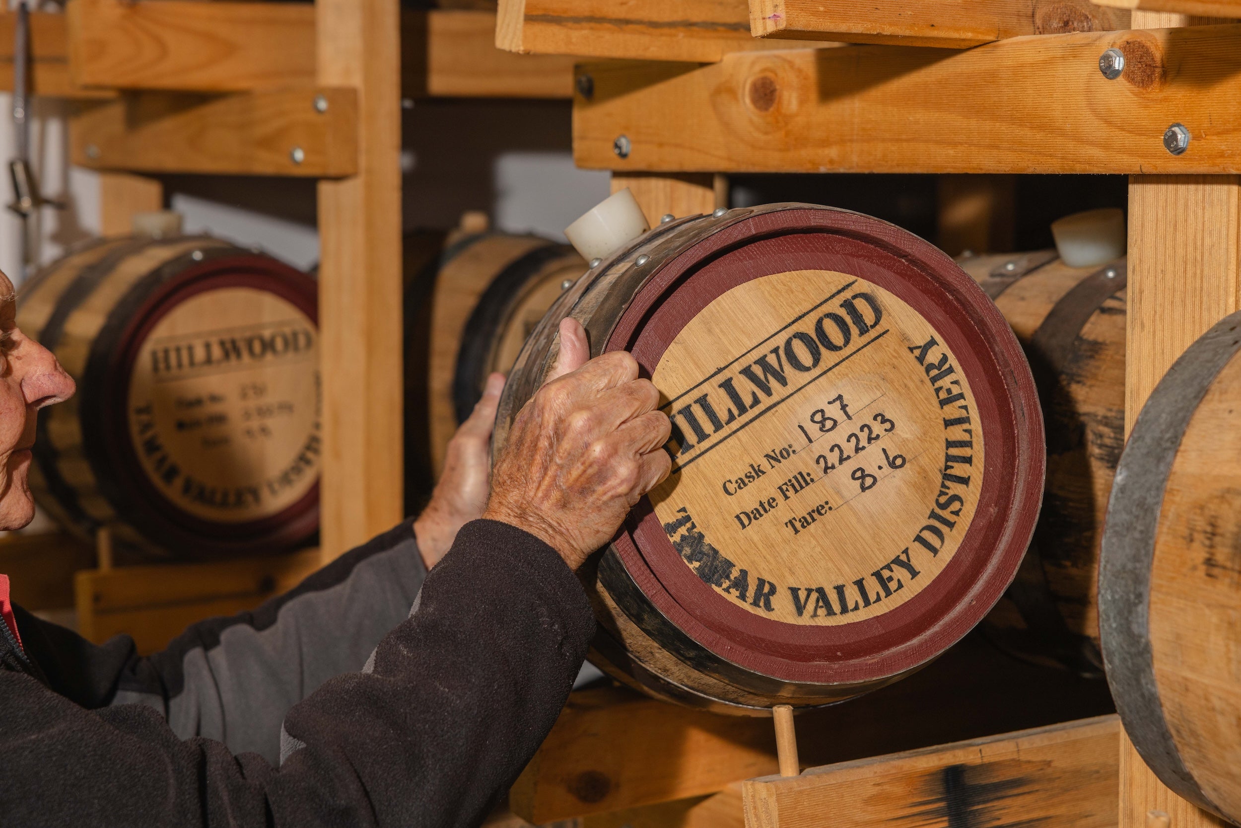 Paul pulling a handmade Tasmanian whisky cask off the rack