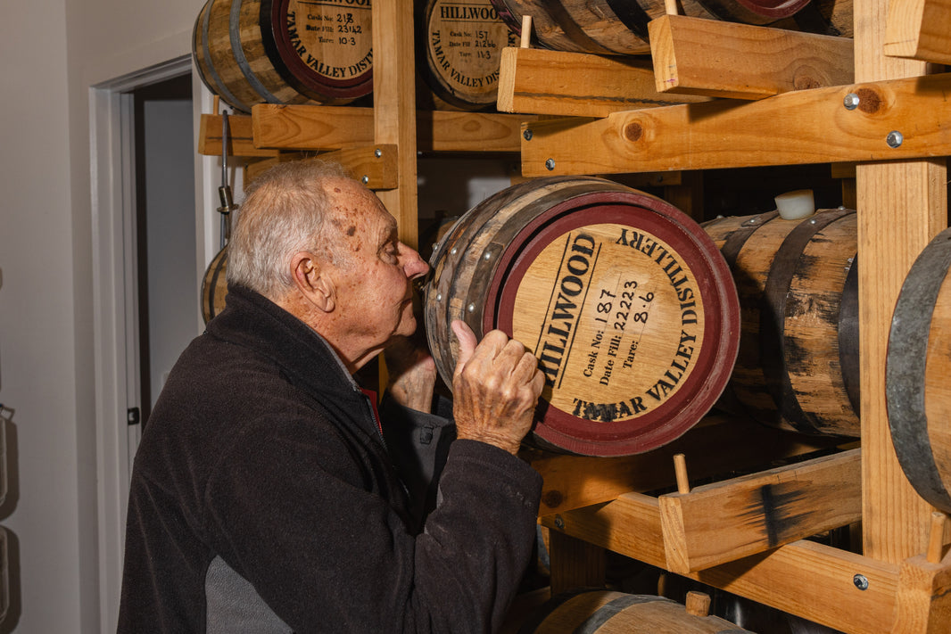 Paull holding a Hillwood Whisky handmade cask to his nose and smelling the Hillwood Whisky inside.