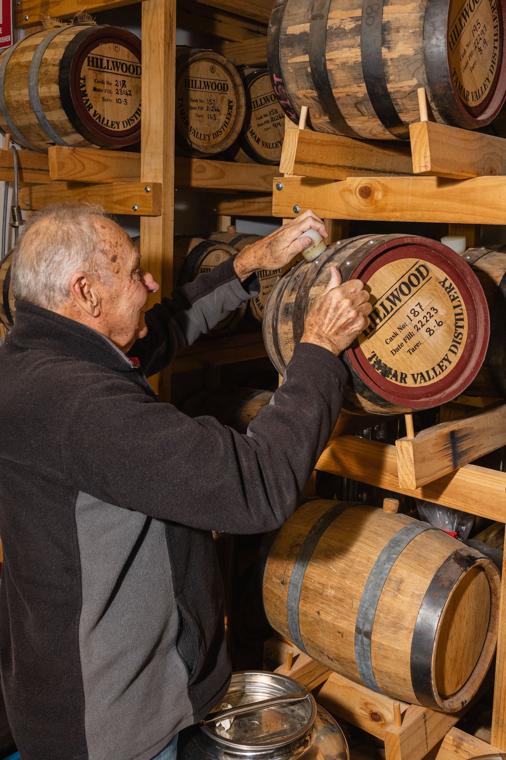Paul pulling the stopper from one of the handmade Tasmanian whisky casks in the distillery