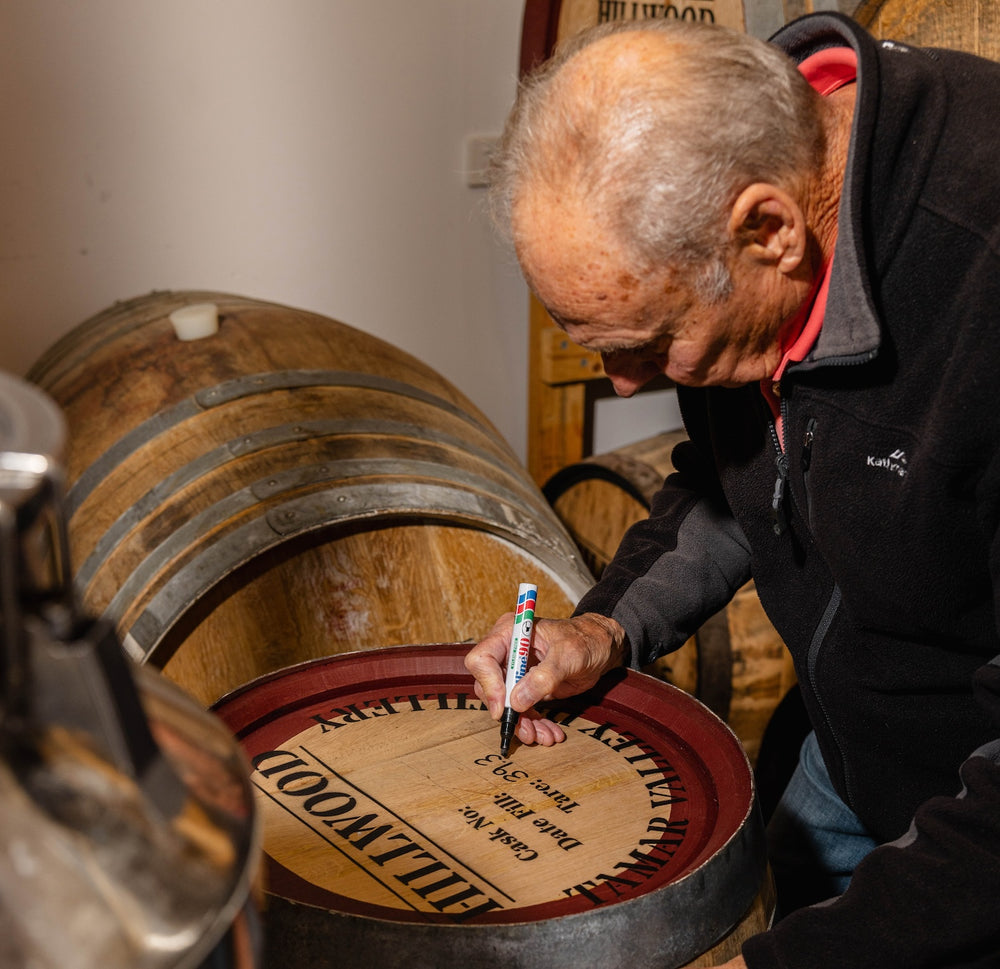 Paul writing the details of the Tasmanian whisky in the Tasmanian whisky cask by hand.