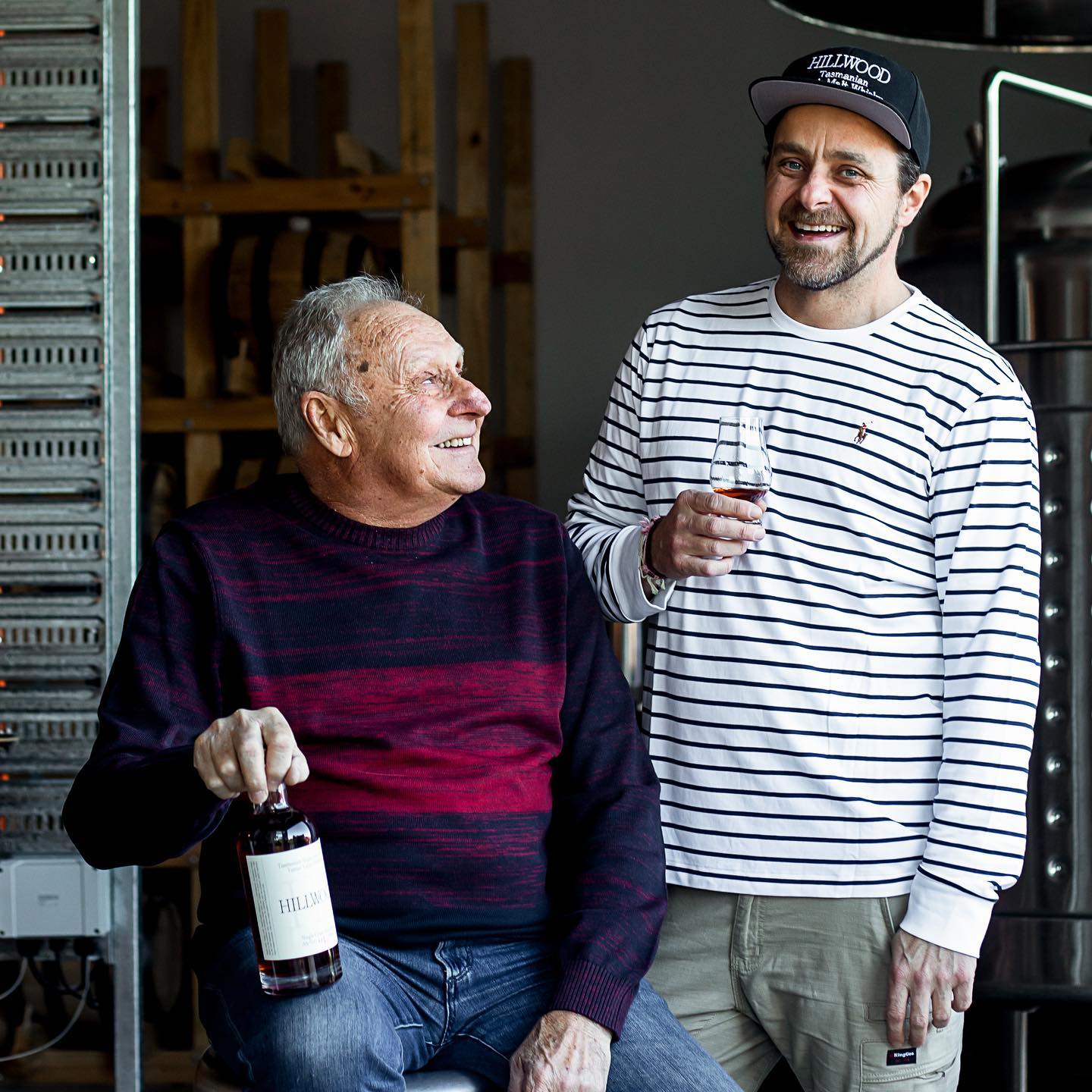 Hillwood Whisky head distiller Paul, and manager Ollie (father and son) sharing a dram of single malt Hillwood Whisky together outside the distillery.